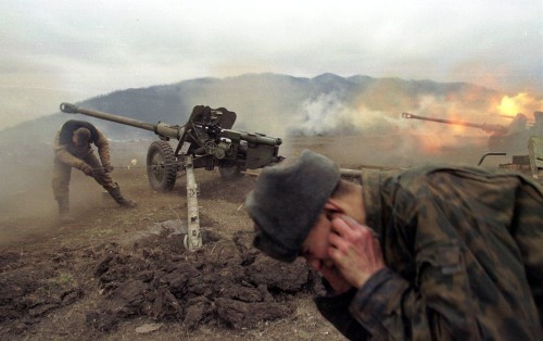 Russian soldiers fire artillery at rebel positions near the village of Duba-Yurt, 30 kilometers (18 miles) south of the capital Grozny, Saturday, Jan. 22, 2000. Russian troops battled Islamic rebels Sunday in increasingly intense war for control of Grozny, military officials said. (AP Photo/Maxim Marmur)